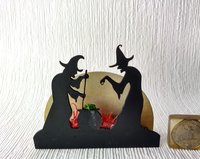 Halloween miniature withches with cauldron silhouette in backlit green light from cauldron and red light to suggest fire and flames Battery operated no external wires