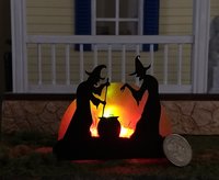 Halloween miniature withches with cauldron silhouette in backlit green light from cauldron and red light to suggest fire and flames Battery operated no external wires