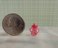 Dollhouse miniature holiday-themed sippy cup with easy grip handles REF Pink body, cardinal, pair of mittens