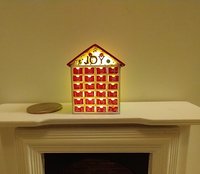 1:12 Dollhouse light up advent calendar with JOY sign above the twenty-four openable drawers Battery operated miniature holiday LEDs decor No external wires