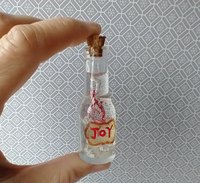 Dollhouse miniature battery lighted glass bottle red glitter glow-in-the-dark cutouts and abstract JOY ornament inside bottle for 12th or play scale dioramas No external wires