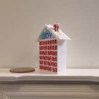 1:12 Dollhouse advent calendar with JOY sign above the twenty-four openable drawers REF Mere JOY