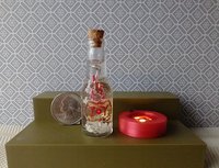Dollhouse miniature battery lighted glass bottle red glitter glow-in-the-dark cutouts and abstract JOY ornament inside bottle for 12th or play scale dioramas No external wires