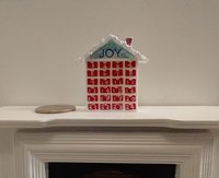 1:12 Dollhouse advent calendar with JOY sign above the twenty-four openable drawers REF Mere JOY