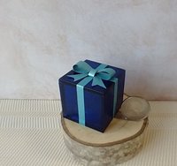Miniature light up gift box in translucent blue with a light blue shimmery gift bow Battery lighted festisve gift box for mini holiday scene display REF Blue