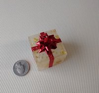 Miniature light up gift box in golden flakes with a  red gift bow Battery lighted festive gift box for mini holiday scene display REF Golden flakes red bow