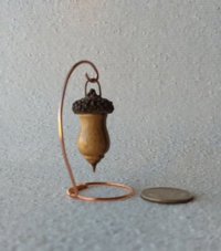 Miniature lathe turned zebrawood bird house with acorn cap on copper wire stand
