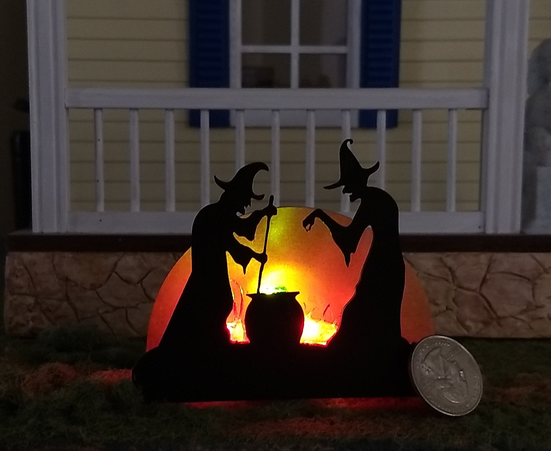 Halloween miniature withches with cauldron silhouette in backlit green light from cauldron and red light to suggest fire and flames Battery operated no external wires