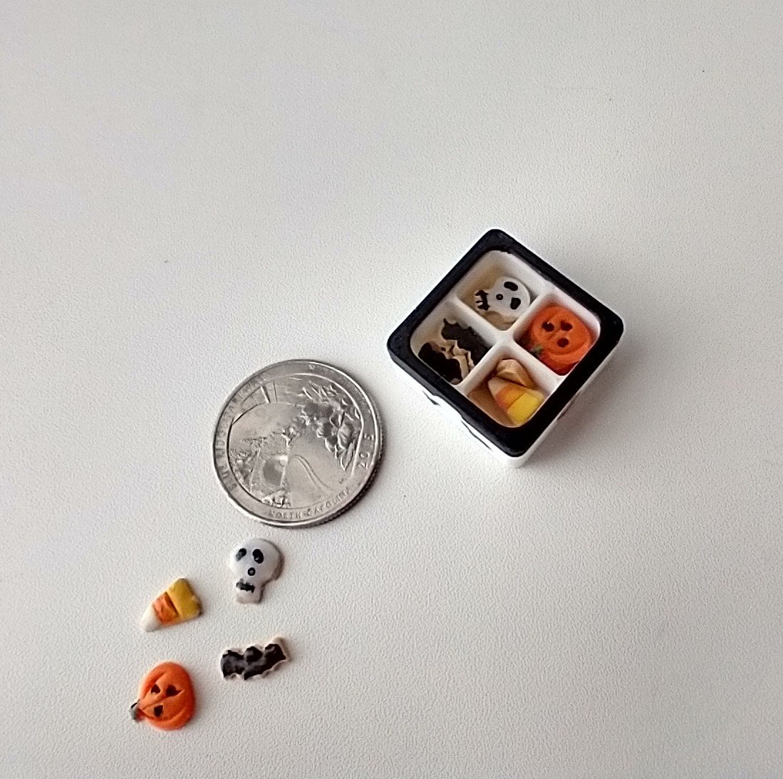 1:12 scale miniature gift boxed Halloween cookies 16 assorted pumpkins skulls candy corn and bats in box with dividers and clear window REF White base