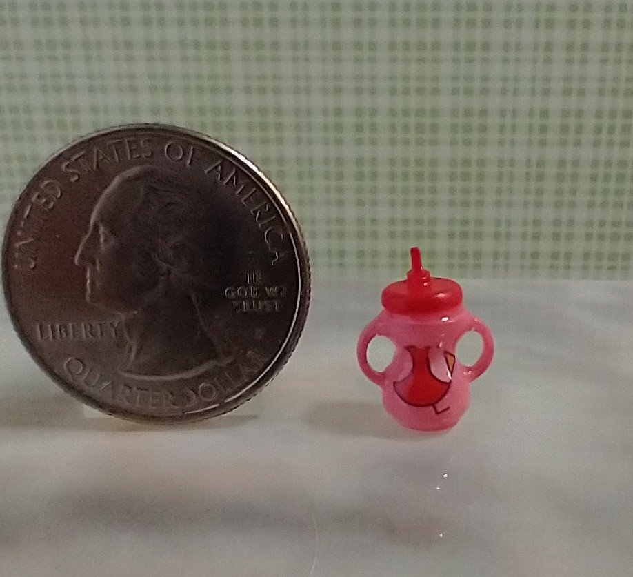 Dollhouse miniature holiday-themed sippy cup with easy grip handles REF Pink body, cardinal, pair of mittens