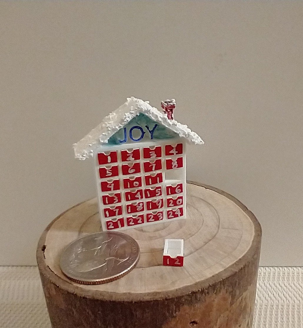 1:12 Dollhouse advent calendar with JOY sign above the twenty-four openable drawers REF Mere JOY