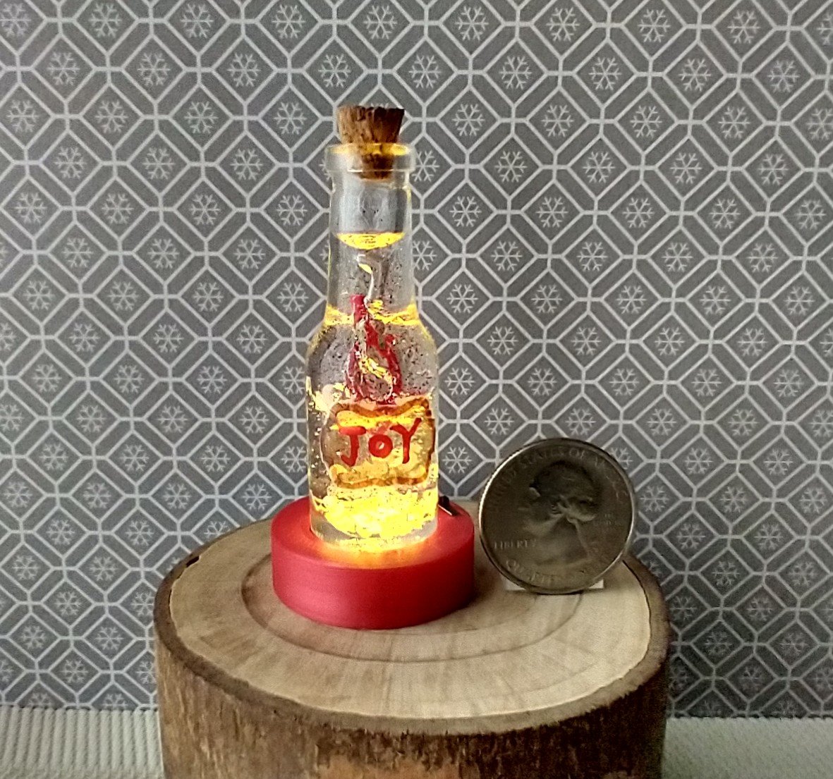 Dollhouse miniature battery lighted glass bottle red glitter glow-in-the-dark cutouts and abstract JOY ornament inside bottle for 12th or play scale dioramas No external wires