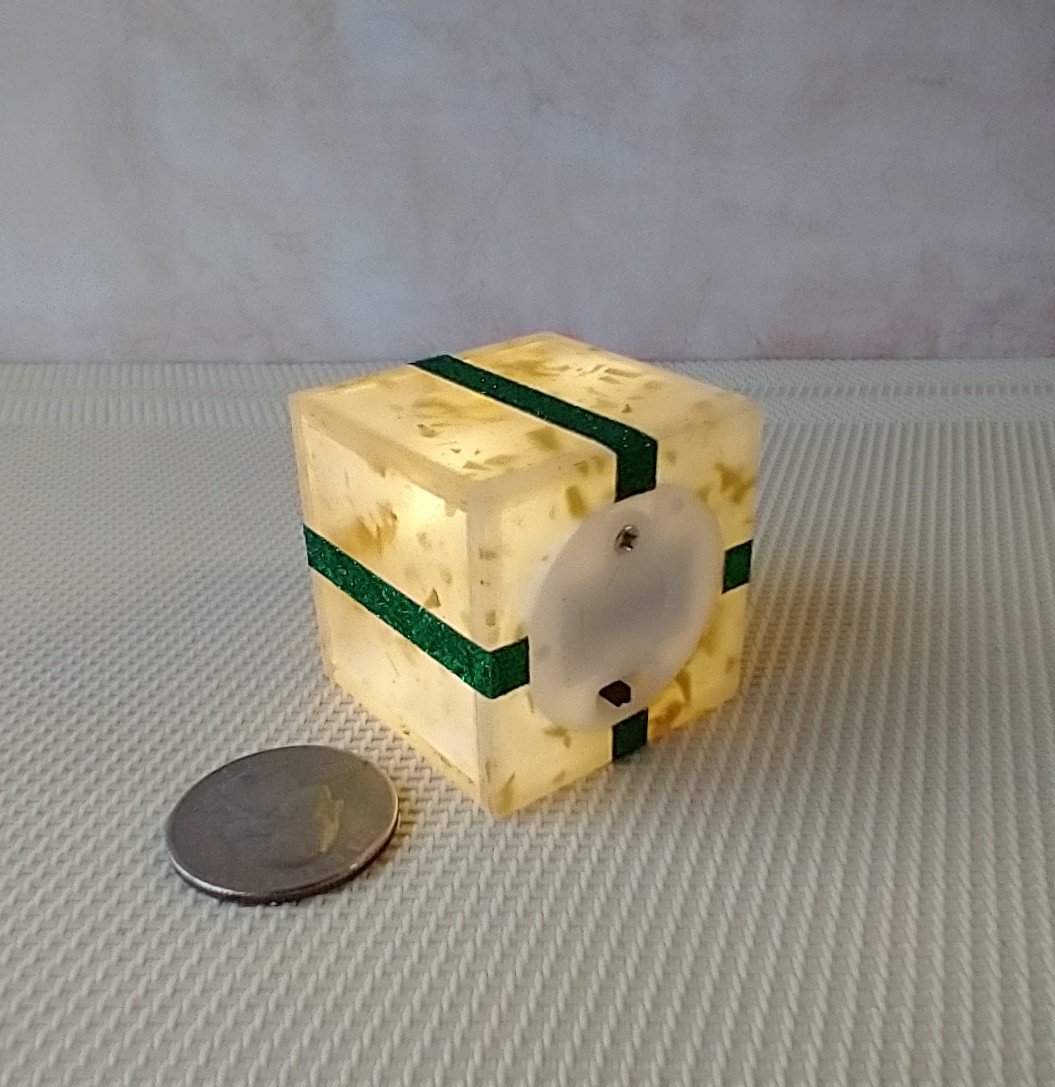Miniature light up gift box in golden flakes with a green gift bow Battery lighted festive gift box for mini holiday scene display REF Golden flake green bow