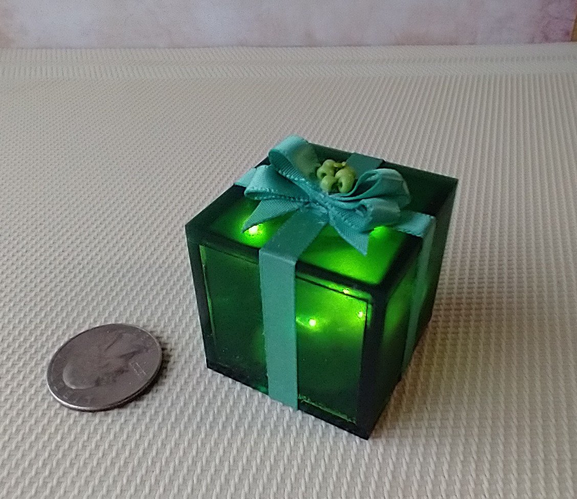 Miniature light up gift box in green with a light green gift bow Battery lighted festive gift box for mini holiday scene display REF Green