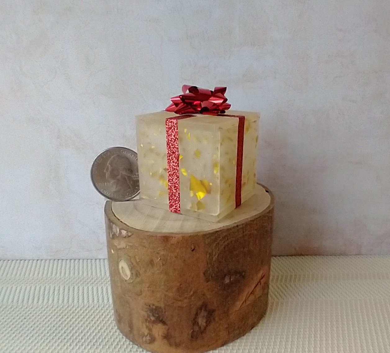 Miniature light up gift box in golden flakes with a  red gift bow Battery lighted festive gift box for mini holiday scene display REF Golden flakes red bow