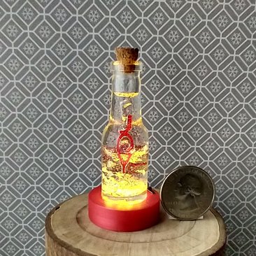 Dollhouse miniature battery lighted glass bottle red glitter glow-in-the-dark cutouts and abstract JOY ornament inside bottle for 12th or play scale dioramas No external wires