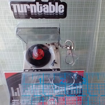 Miniature turntable keychain with motion and light - it spins and  lights up